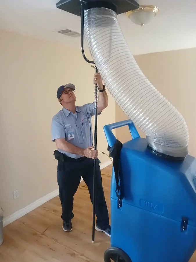 Furnace Tune-Up technician using HEPA equipment in Hanahan